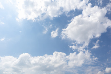 Beautiful blue clear sky with white clouds background in sunny day and copy space. Nature bright sky background image. Summer blue sky with sunlight. Texture for Design. Natural cloudy Wallpaper.