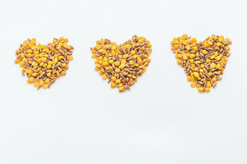 a few shots of lentils and spelt in the form of heart on a white background. Healthy lifestyle, vegetarianism. Fight with excess weight.