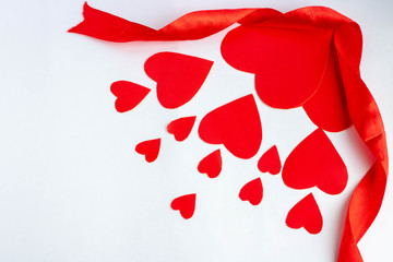 Flying red paper hearts on white background. Valentine's Day. Symbol of love. Copy space