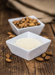 Portion of healthy Ground Almonds on an old wooden table (selective focus; close-up shot)