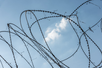 Barbed wire fence in the middle of a white cloud