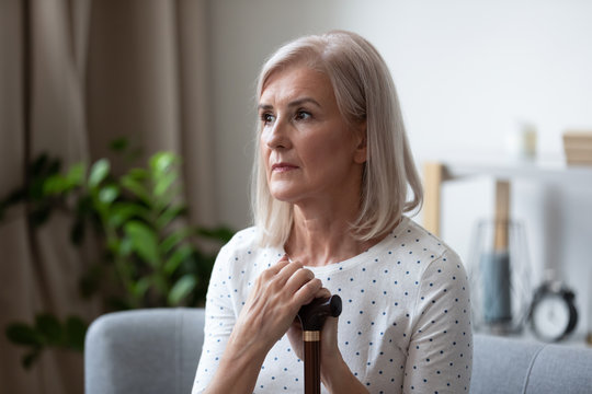 Upset Senior Woman With Cane Feel Lonely Thinking