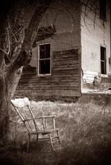 Old Rocking Chair in front of Abanboned Hauted House