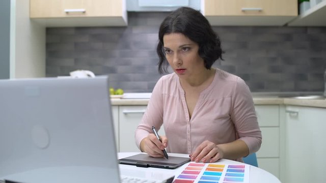 Graphic designer drawing on tablet, female illustrator working on project, job