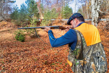 Naklejka premium hunter with weapon chasing in the forest