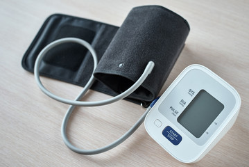 Digital blood pressure monitor on the table, closeup. Helathcare and medical concept
