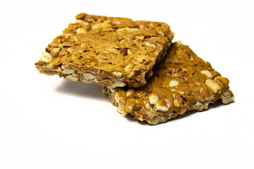 Crispy peanut jaggery bar on white background