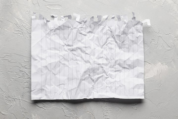 Crumpled paper on a light background. Place for text.