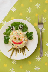 Creatively decorated octopus salad. Children's menu on a green background