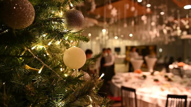 Christmas tree with decorations and a garland at the reception in a premium restaurant