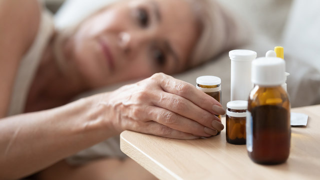 Close Up Of Unhealthy Senior Woman Taking Meds At Home