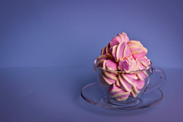 Top view of the pastel marshmallows on caps a color background. Minimal style.