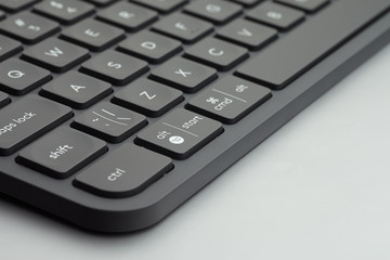 Close-up black keyboard keys on grey table