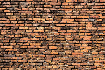 Beautiful orange brick wall that are not plastered background and texture.