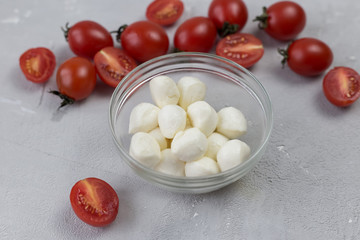 mozzarella and cherry tomatoes on a gray background