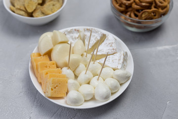  on a white plate lies assorted cheese appetizer different varieties