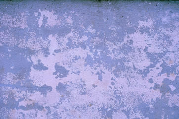 Fragment of old house wall close-up. Blue background. Peeling plaster on concrete surface. Cracks in paint. light blue tinted. Copy space. Place for text. Selective focus image. 