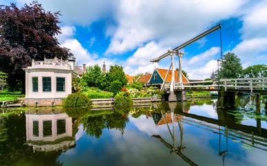 Kwakel draw bridge in the historic town Edam, Netherlands. Kwakel draw bridge is an old bridge with counter-balance construction. Calm view of the canal, waterfront houses and church tower