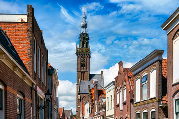 Cityscape with Church of Our Dear Lady in Edam. Although most of the church was demolished in 1882, the 15th-century tower and carillon remain standing today. - obrazy, fototapety, plakaty