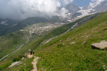 Fototapeta na wymiar Hiking for health in Italian alps landscape