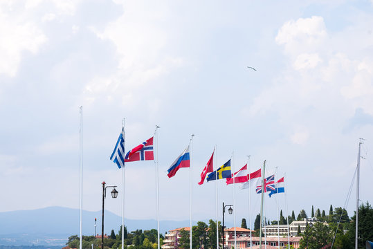 Port on Lake Garda. Flags of European countries. Summer landscape. Cisano, Italy. Europe.