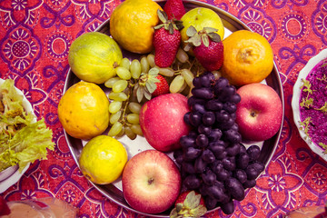 Naklejka na ściany i meble Mixed fruits platter on colourful background