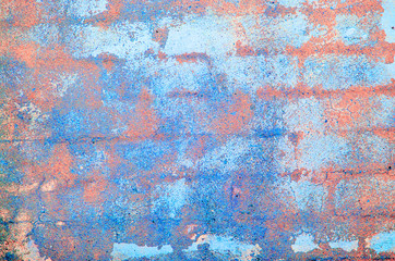 Old concrete wall. Peeling plaster on wall of house, building or fence surface. Toning in bright neon pink and blue colors. Modern urban backdrop. Copy space. Place for text. Selective focus image.