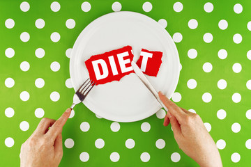 Hands hold flatware above dieting plate, Top View