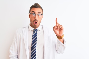 Young handsome therapist man over isolated background pointing finger up with successful idea. Exited and happy. Number one.