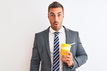Young handsome business man drinking take away coffee over isolated background scared in shock with a surprise face, afraid and excited with fear expression