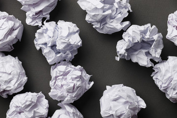 Crumpled paper balls on a gray background. Place for text. Idea concept.