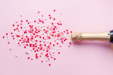Champagne bottle on pink background