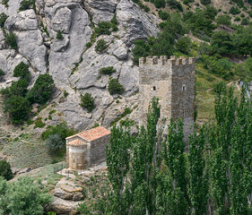 Ancient tower and church near fortress in Sudak, Crimea, Russia.