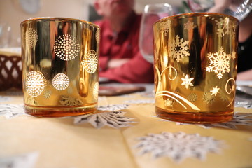 Photophores dorés allumés posés sur une table