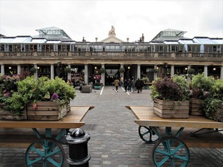 Unrecognizable tourists and locals shopping and visiting at Apple Market in Covent Garden 