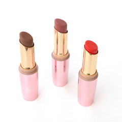 Brown and red lipsticks with pink cap on white background.