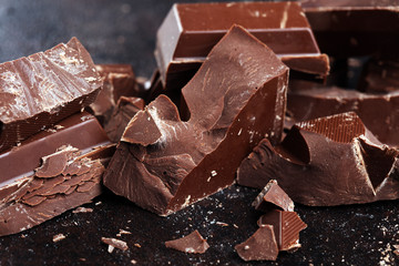 Dark chocolate stack, chips and powder with chocolate bars and block