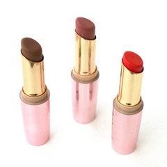 Brown and red lipsticks with pink cap on white background.