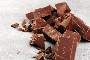 Dark chocolate stack, chips and powder with chocolate bars and block