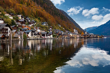 Hallstatter lake and Hallstatt village with blue sky in Austrian Alps / Evening light during autumn season / One of most popular tourist location in Austria