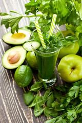 Fresh organic green smoothie with vegetables and greens