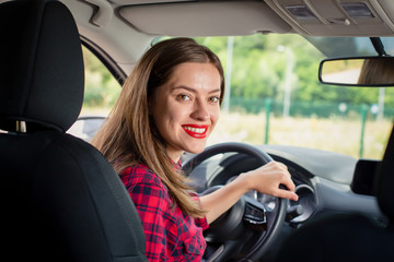Young woman driving a modern car