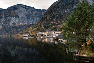 Hallstatter lake and Hallstatt village in Austrian Alps / Evening light during autumn season / One of most popular tourist location in Austria
