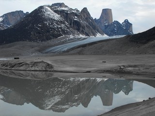 Evening Mount Asgard and reflection on glacier water Auyuittuq national Park Baffin Island