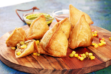 Vegetarian samsa or samosas.Indian special traditional street food fried punjabi samosa or Coxinha,...