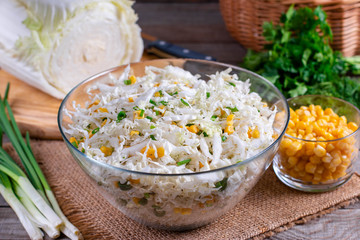 Chinese cabbage salad with sweet corn in a glass bowl