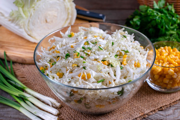 Chinese cabbage salad with sweet corn in a glass bowl
