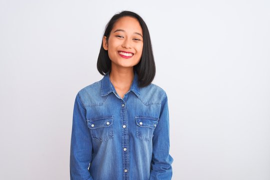 Young Beautiful Chinese Woman Wearing Denim Shirt Standing Over Isolated White Background With A Happy And Cool Smile On Face. Lucky Person.