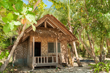 Fototapeta na wymiar Beautiful beach house on tropical island in paradise. Villa Bungalow at Tropical beach shore