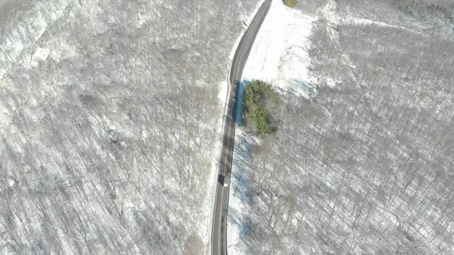Aerial of Delivery Truck Driving on Winter Country Road